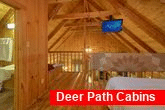 Loft bedroom with TV and Jacuzzi in cabin