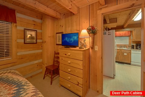 King bedroom with TV in Rustic cabin - Just Barely Making It