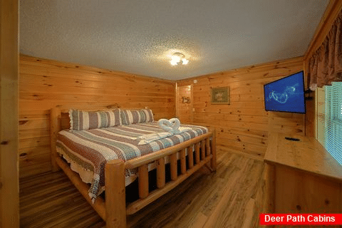 Queen bedroom with TV in Pigeon Forge cabin - A Step Away