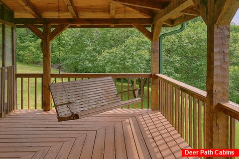 Porch Swing and wooded view at 3 bedroom cabin - Dogwood Acre